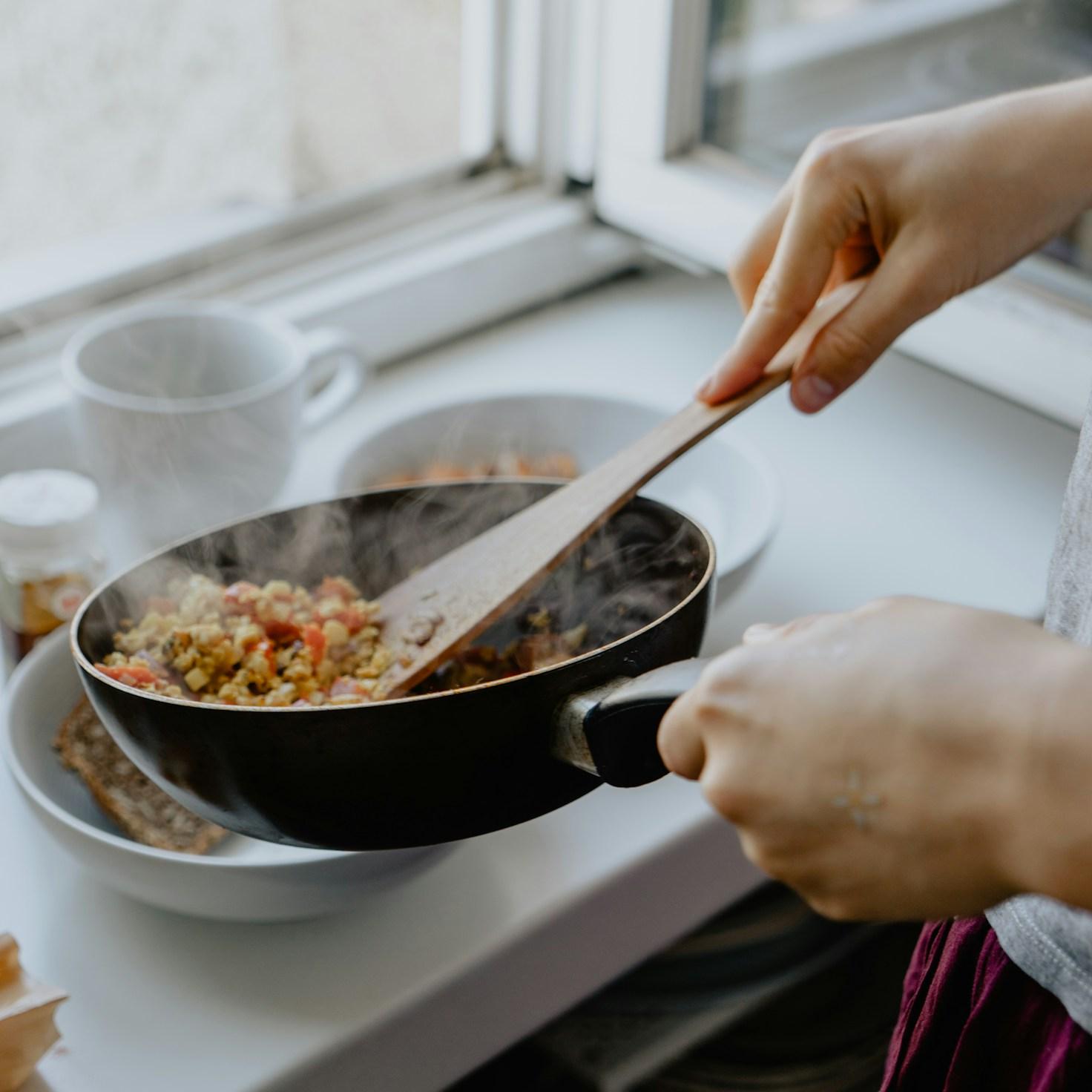 Community members collaborating in a contemporary kitchen, sharing recipes and techniques